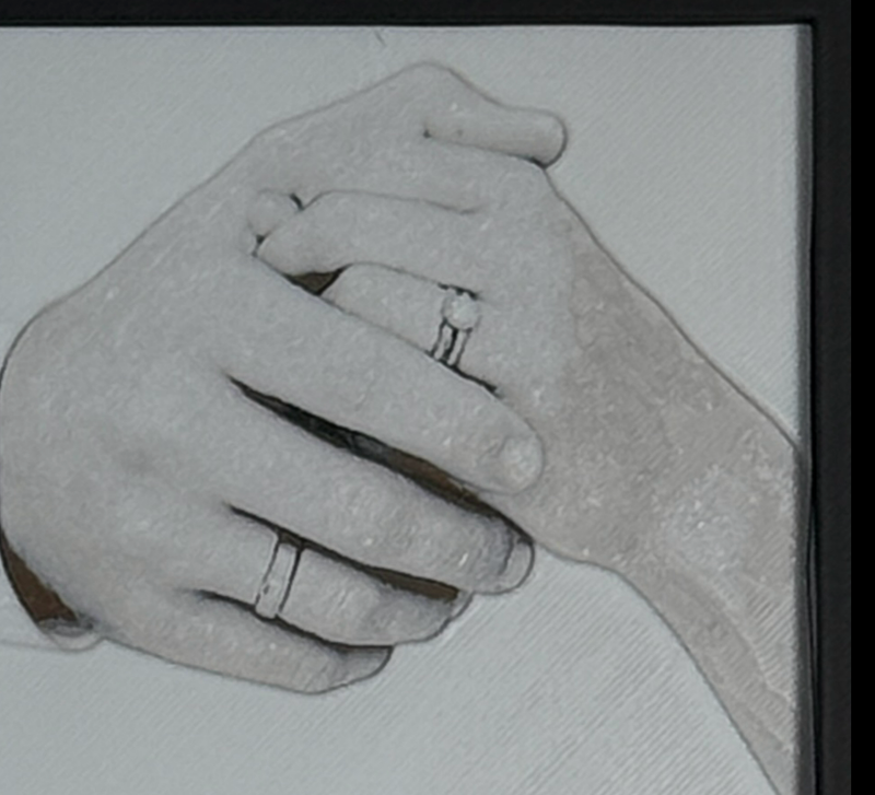Custom framed 3D layered art piece showing a wedding couple's clasped hands with rings, printed in layers by WTx3D.