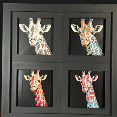 Four-panel framed geometric giraffe layered 3D art set showing the giraffe design in Heritage, Crimson Ice, Royal Gold, and Teal Orange color palettes inside a charcoal matte four-pack display frame.