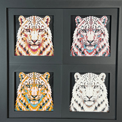 Four-panel framed geometric snow leopard layered art set showing the same front-facing leopard portrait in four WTX3D color palettes, arranged in a charcoal black 2x2 frame with sharp facial detail, spotted fur texture, and high-contrast layered color.