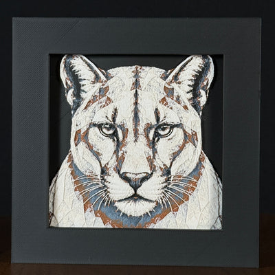 Geometric mountain lion framed layered 3D art in Heritage color palette, featuring a bold mountain lion portrait with soft white, gray, black, and neutral brown layered details inside a charcoal matte display frame.