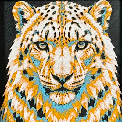 Geometric snow leopard framed layered 3D art in Teal Orange color palette, featuring a snow leopard portrait with turquoise, orange, black, and white layered details inside a charcoal matte display frame.