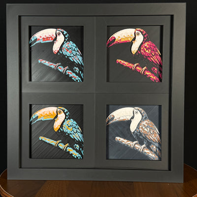 Four-panel framed geometric toucan layered 3D art set showing the toucan design in Heritage, Crimson Ice, Royal Gold, and Teal Orange color palettes inside a charcoal matte four-pack display frame.