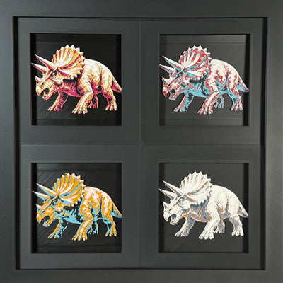 Four-panel framed geometric Triceratops layered 3D art set showing the Triceratops design in Heritage, Crimson Ice, Royal Gold, and Teal Orange color palettes inside a charcoal matte four-pack display frame.