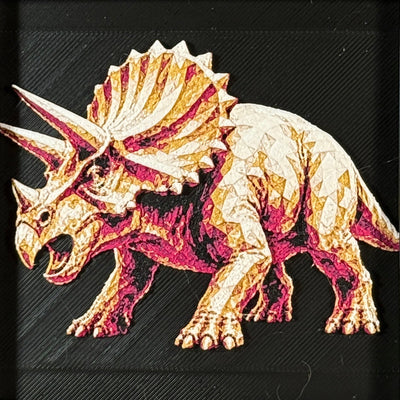 Framed geometric Triceratops layered 3D art piece featuring a stylized dinosaur design in a rich Royal Gold color palette with warm gold and orange highlights.