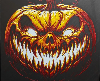 Framed 3D layered art piece featuring a menacing, evil jack-o'-lantern pumpkin monster with sharp jagged teeth and glowing yellow eyes against a dark background.