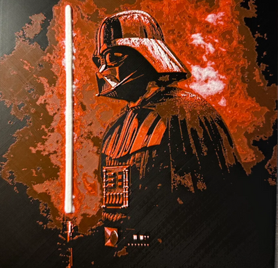 Framed 3D layered art piece featuring a dramatic, high-contrast stylized illustration of an iconic sci-fi dark villain character in a black helmet and cape, shown in profile. The character is holding a glowing vertical red lightsaber blade on the left. The background features an intense, highly textured aura of explosive red and orange smoke against a solid black backdrop.