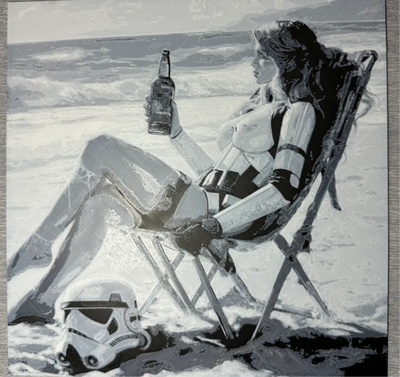 Framed 3D layered art piece featuring a humorous monochrome grayscale illustration of a woman wearing sci-fi trooper-inspired armor elements and a bikini, relaxing on a folding lawn chair at the beach while holding up a glass bottle. An iconic sci-fi soldier helmet rests on the sand next to her chair against a background of crashing ocean waves.