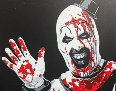 Framed 3D layered art piece featuring a sinister black-and-white slasher clown with a maniacal grin covered in bright red blood, wearing a tiny black top hat and waving with a bloody gloved hand against a dark background.