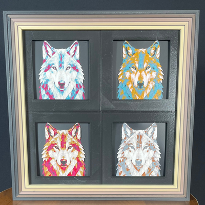 Framed geometric wolf collection 4-pack featuring four wolf portraits displayed in distinct color palettes within a premium 2x2 display frame.