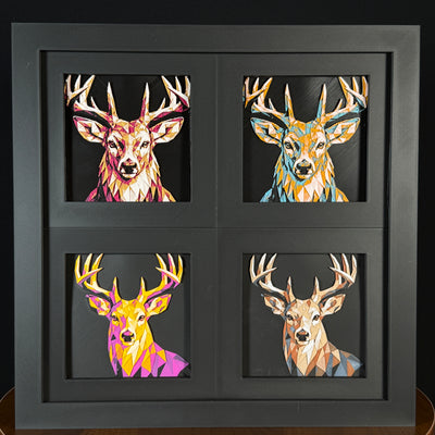 Four-panel framed geometric Buck Deer layered 3D art set showing the Buck deer design in Heritage, Crimson Ice, Royal Gold, and Teal Orange color palettes inside a charcoal matte four-pack display frame.