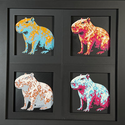 Four-panel framed geometric capybara layered 3D art set showing the capybara design in Heritage, Crimson Ice, Royal Gold, and Teal Orange color palettes inside a charcoal matte four-pack display frame.