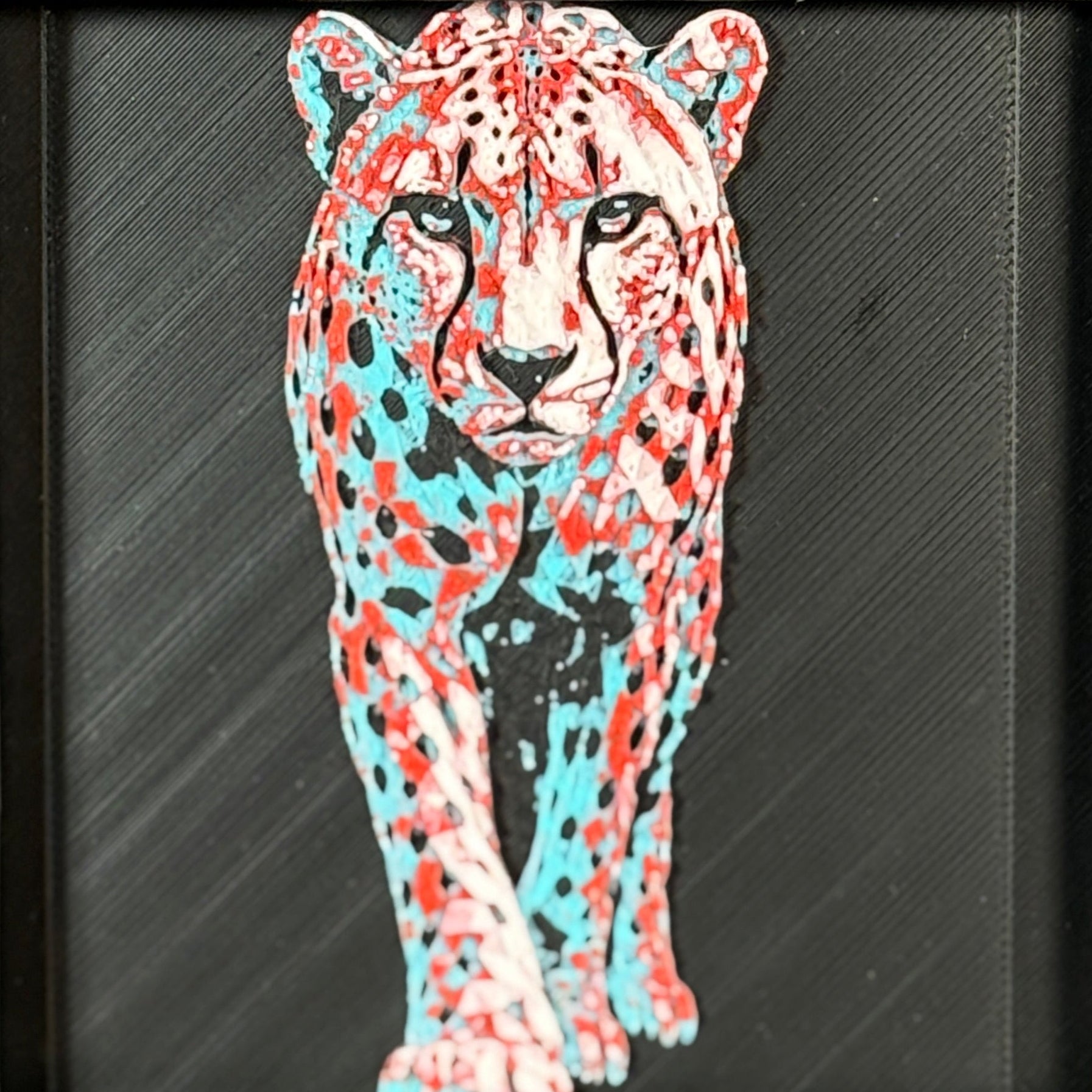 Geometric cheetah framed layered 3D art in Crimson Ice color palette, featuring a standing cheetah with cyan, red, magenta, black, and white layered details inside a charcoal matte display frame.