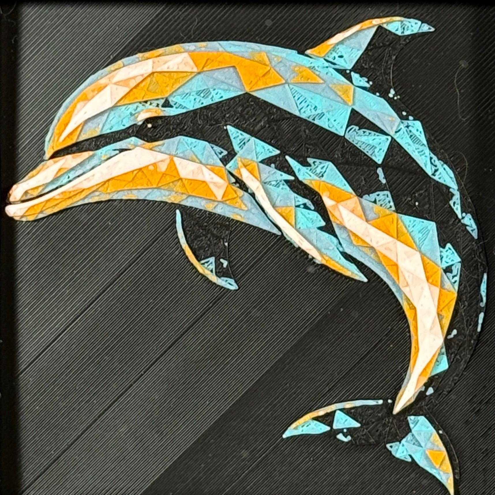 Geometric dolphin framed layered 3D art in Teal Orange color palette, featuring a leaping dolphin with turquoise, orange, black, and white layered details inside a charcoal matte display frame.