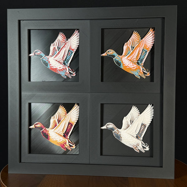 Four-panel framed geometric duck layered 3D art set showing the duck design in Heritage, Crimson Ice, Royal Gold, and Teal Orange color palettes inside a charcoal matte four-pack display frame.