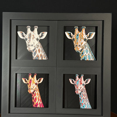 Four-panel framed geometric giraffe layered 3D art set showing the giraffe design in Heritage, Crimson Ice, Royal Gold, and Teal Orange color palettes inside a charcoal matte four-pack display frame.