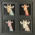 Four-panel framed geometric giraffe layered 3D art set showing the giraffe design in Heritage, Crimson Ice, Royal Gold, and Teal Orange color palettes inside a charcoal matte four-pack display frame.