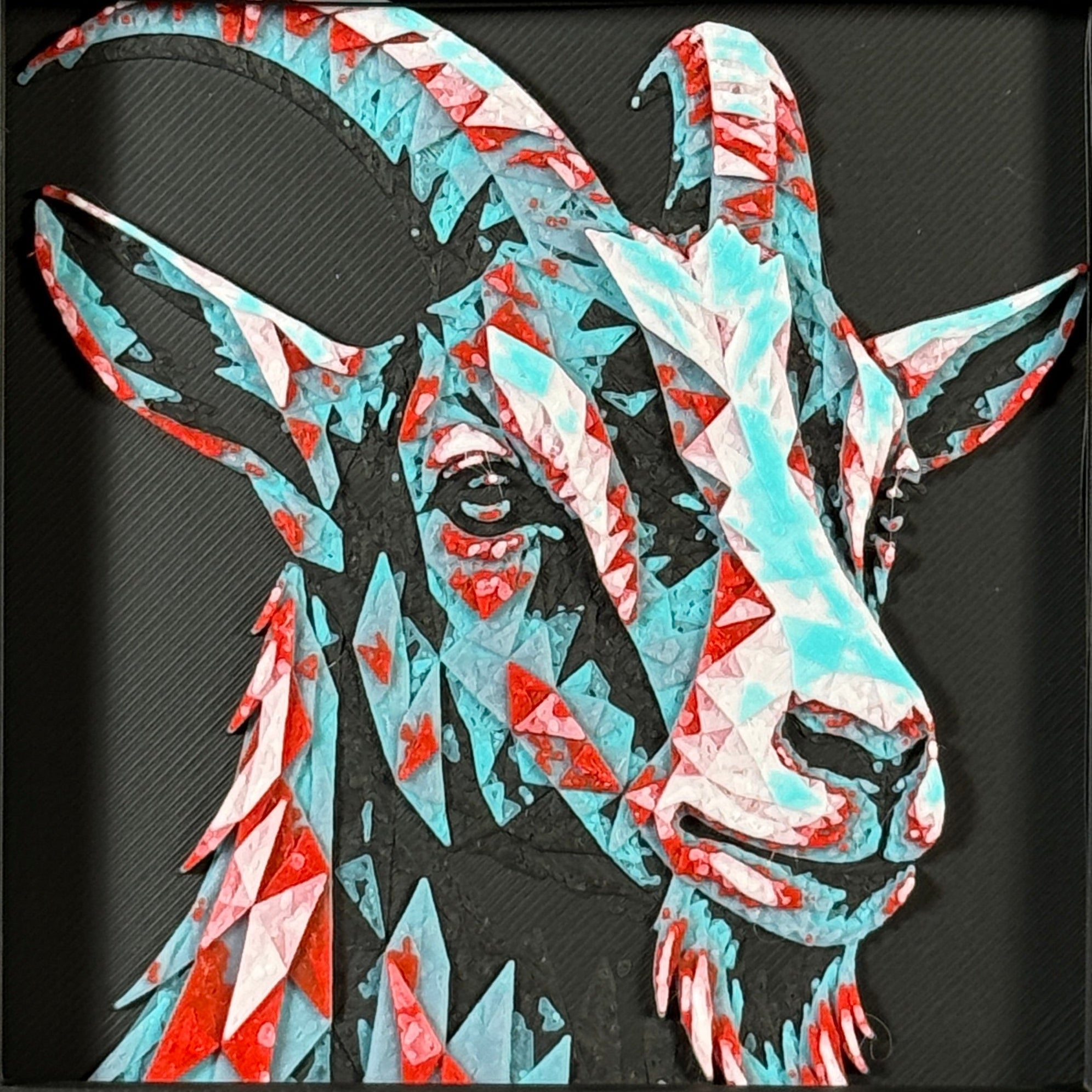 Geometric goat framed layered 3D art in Crimson Ice color palette, featuring a bold goat portrait with cyan, red, magenta, black, and white layered details inside a charcoal matte display frame.