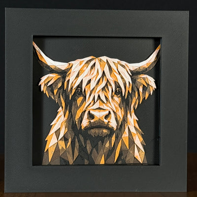 Geometric cow framed layered 3D art in Heritage color palette, featuring a bold cow portrait with soft white, gray, black, and neutral brown layered details inside a charcoal matte display frame.