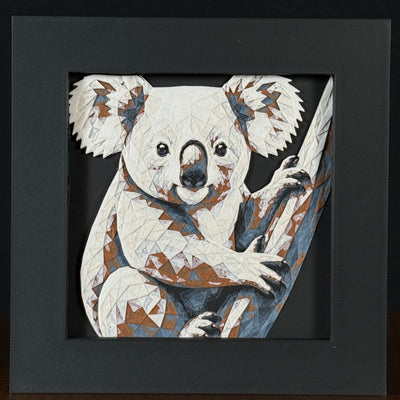 Geometric koala framed layered 3D art in Heritage color palette, featuring a bold cow portrait with soft white, gray, black, and neutral brown layered details inside a charcoal matte display frame.