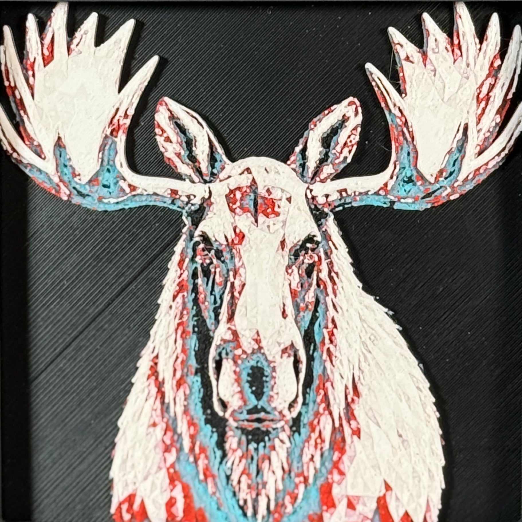Geometric moose framed layered 3D art in Teal Orange color palette, featuring a moose portrait with turquoise, orange, black, and white layered details inside a charcoal matte display frame.
