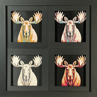 Four-panel framed geometric moose layered art set showing the same front-facing moose portrait in four WTX3D color palettes, arranged in a charcoal black 2x2 frame with large antlers, detailed fur texture, and high-contrast layered color.