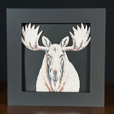 Geometric moose framed layered 3D art in Heritage color palette, featuring a bold moose portrait with soft white, gray, black, and neutral brown layered details inside a charcoal matte display frame.