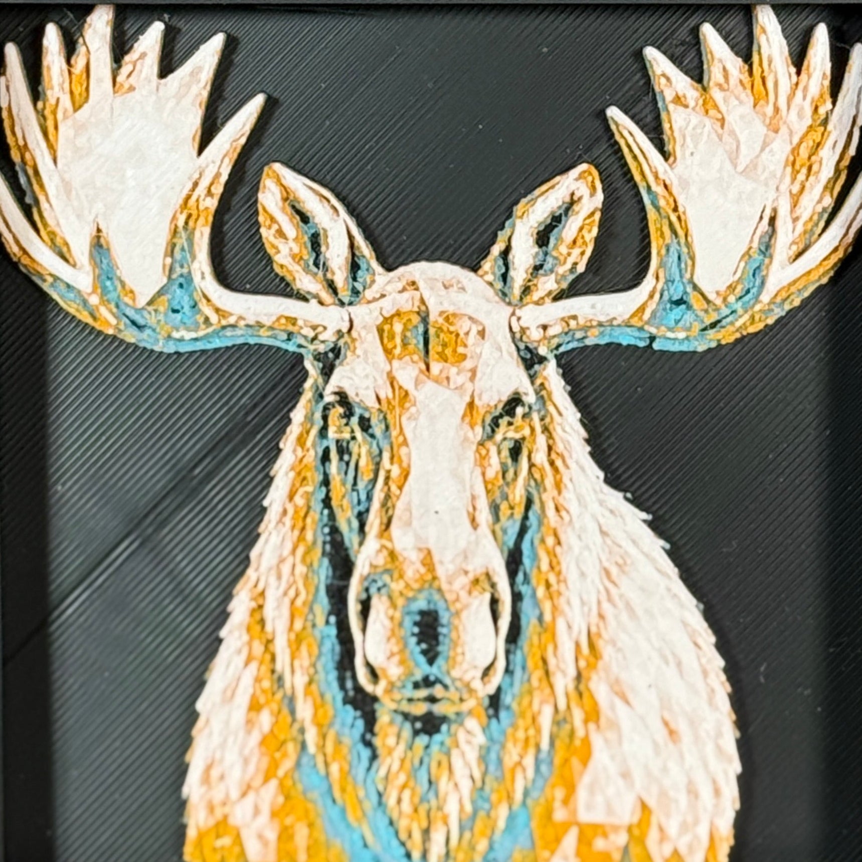 Geometric moose framed layered 3D art in Royal Gold color palette, featuring a moose portrait with gold, blue, black, and white layered details inside a charcoal matte display frame.