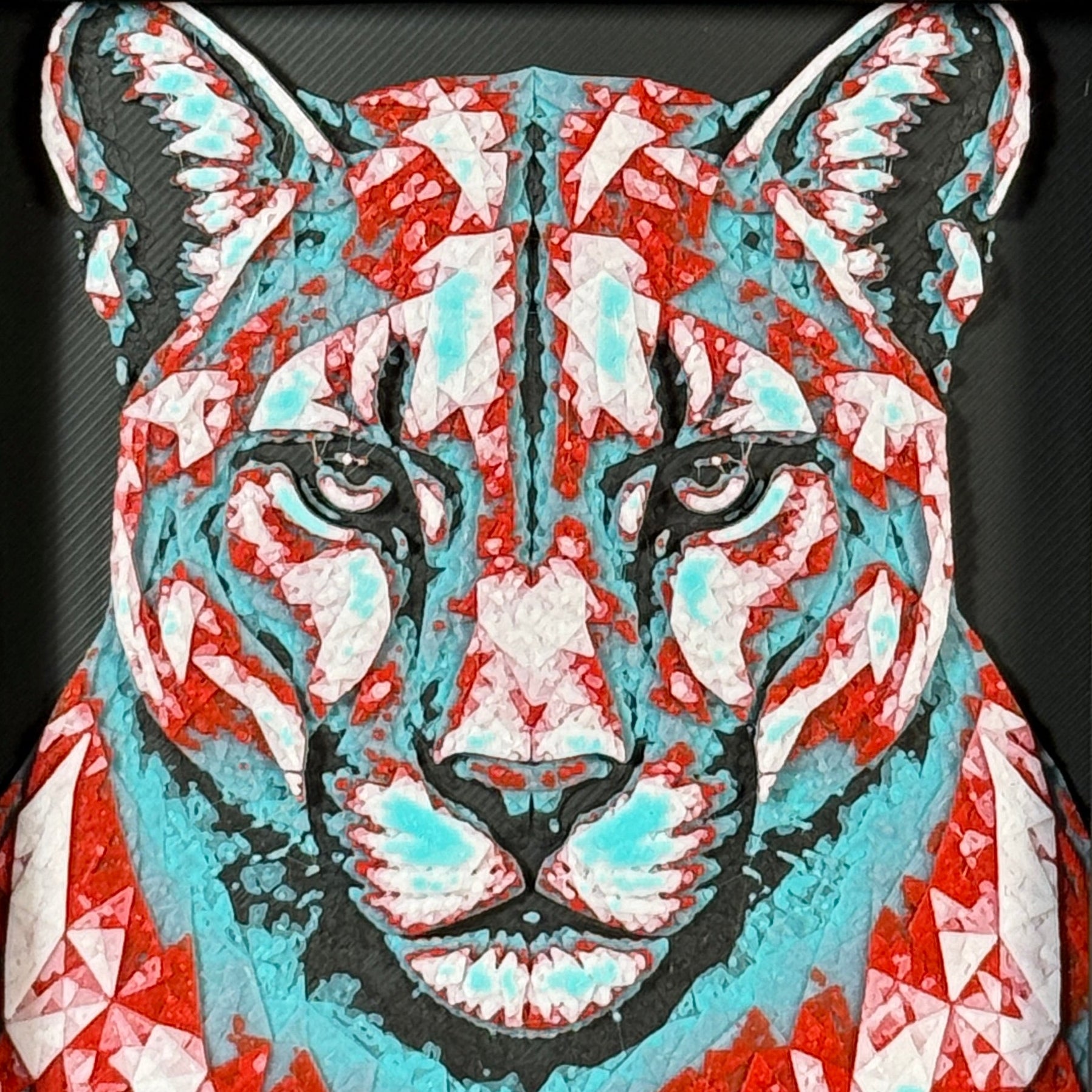 Geometric mountain lion framed layered 3D art in Crimson Ice color palette, featuring a bold mountain lion portrait with cyan, red, magenta, black, and white layered details inside a charcoal matte display frame.