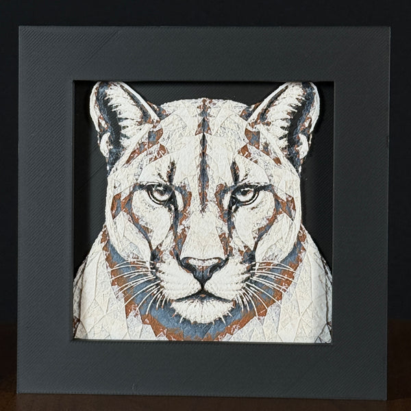 Geometric mountain lion framed layered 3D art in Heritage color palette, featuring a bold mountain lion portrait with soft white, gray, black, and neutral brown layered details inside a charcoal matte display frame.
