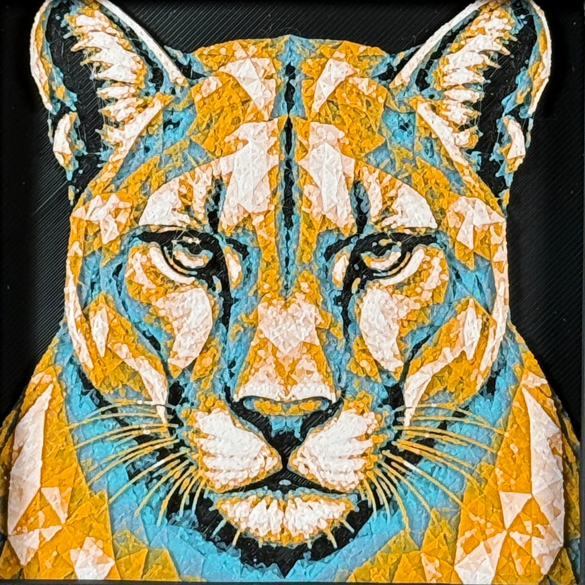 Geometric mountain lion framed layered 3D art in Teal Orange color palette, featuring a bold mountain lion portrait with turquoise, orange, black, and white layered details inside a charcoal matte display frame.