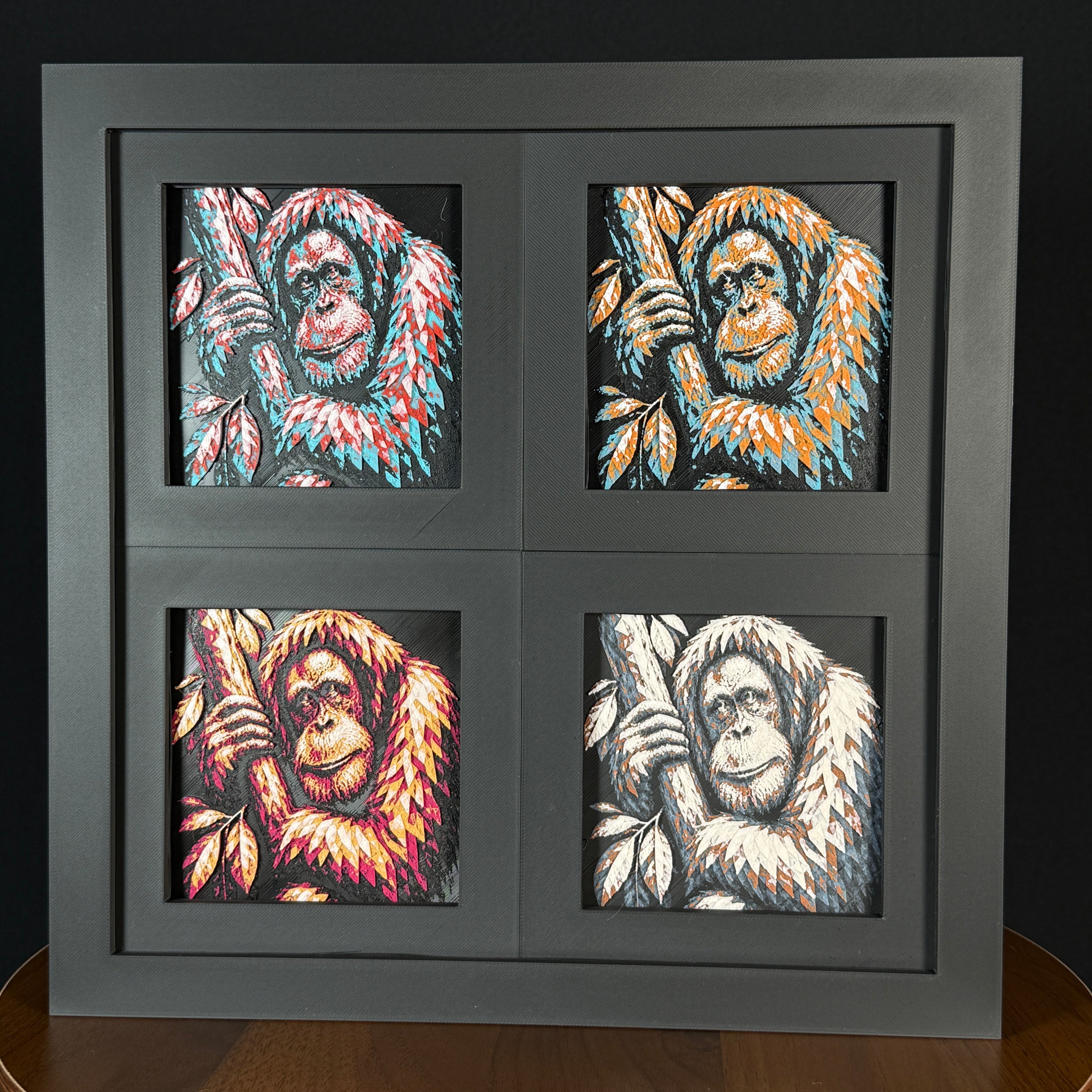 Four-panel framed geometric orangutan layered art set showing the same orangutan design in four WTx3D color palettes, arranged in a charcoal black 2x2 frame with bold animal details, layered texture, and high-contrast colors.