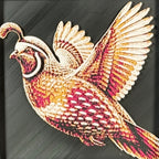Geometric quail framed layered 3D art in Royal Gold color palette, featuring a flying quail with gold, blue, black, and white layered details inside a charcoal matte display frame.