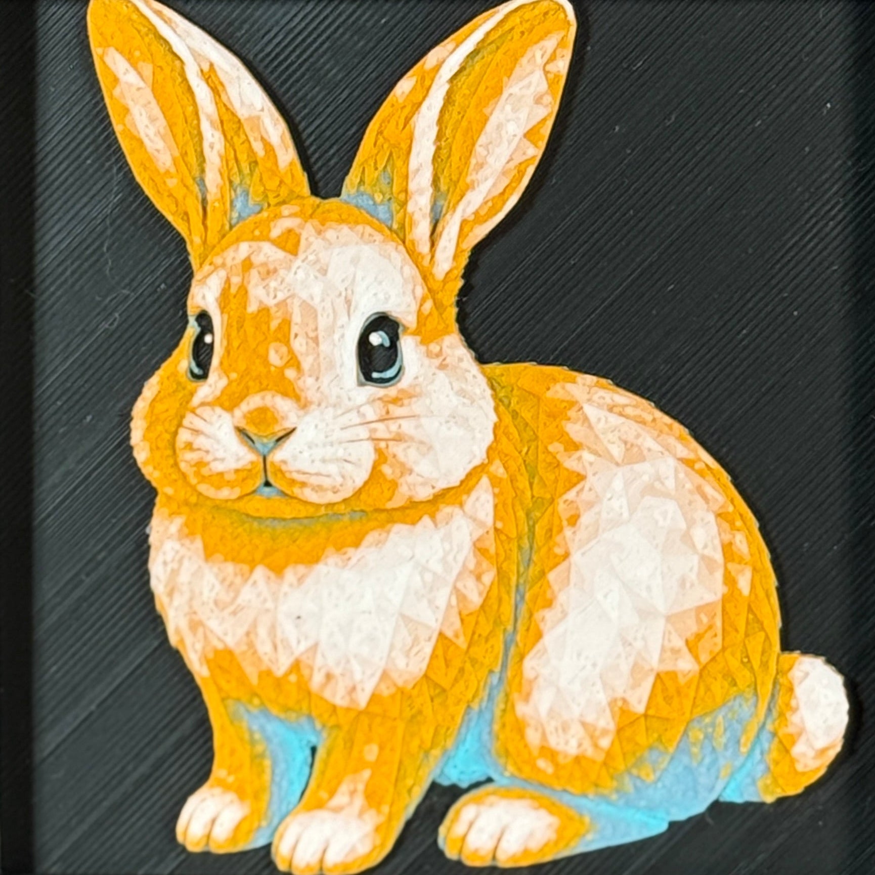 Geometric rabbit framed layered 3D art in Royal Gold color palette, featuring a rabbit portrait with gold, blue, black, and white layered details inside a charcoal matte display frame.