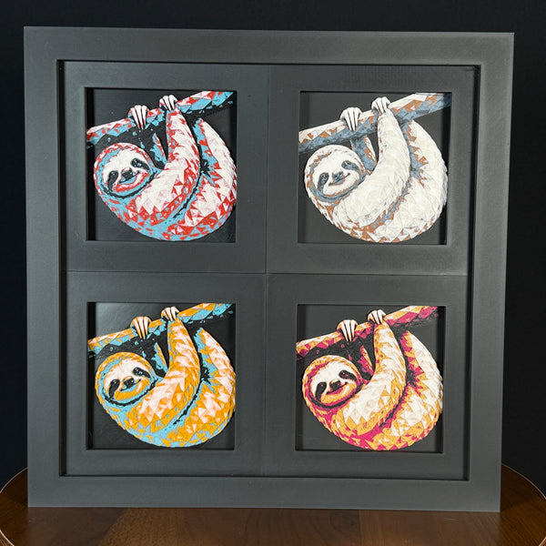 Four-panel framed geometric sloth layered art set showing the same hanging sloth design in four WTX3D color palettes, arranged in a charcoal black 2x2 frame with detailed fur texture, curved branch pose, and high-contrast layered color.