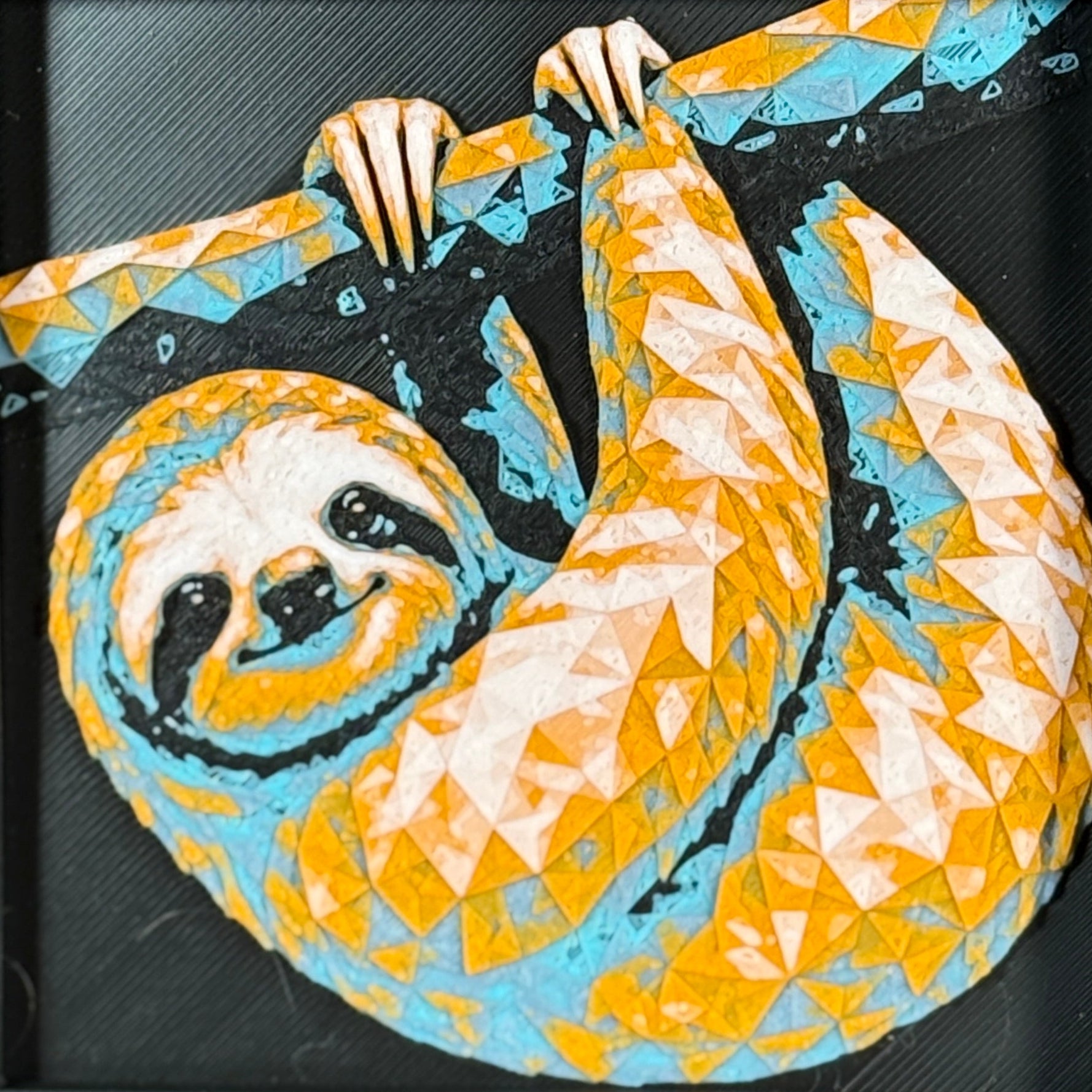 Geometric sloth framed layered 3D art in Teal Orange color palette, featuring a curled sloth design with turquoise, orange, black, and white layered details inside a charcoal matte display frame.