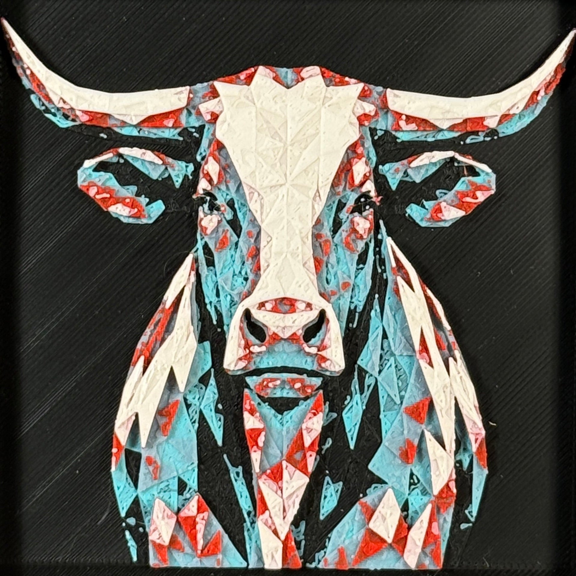 Geometric steer framed layered 3D art in Crimson Ice color palette, featuring a bold steer portrait with cyan, red, magenta, black, and white layered details inside a charcoal matte display frame.