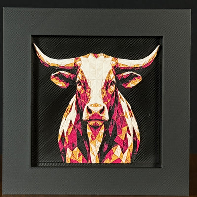 Geometric steer framed layered 3D art in Royal Gold color palette, featuring a bold steer portrait with gold, blue, black, and white layered details inside a charcoal matte display frame.