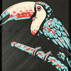 Geometric toucan framed layered 3D art in Crimson Ice color palette, featuring a toucan portrait with cyan, red, magenta, black, and white layered details inside a charcoal matte display frame.