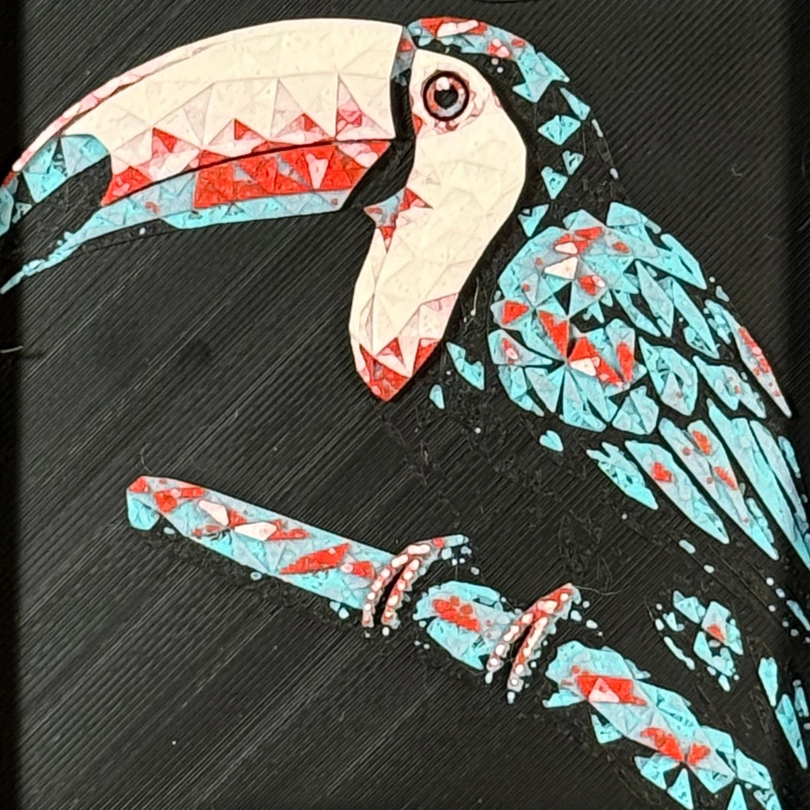 Geometric toucan framed layered 3D art in Crimson Ice color palette, featuring a toucan portrait with cyan, red, magenta, black, and white layered details inside a charcoal matte display frame.