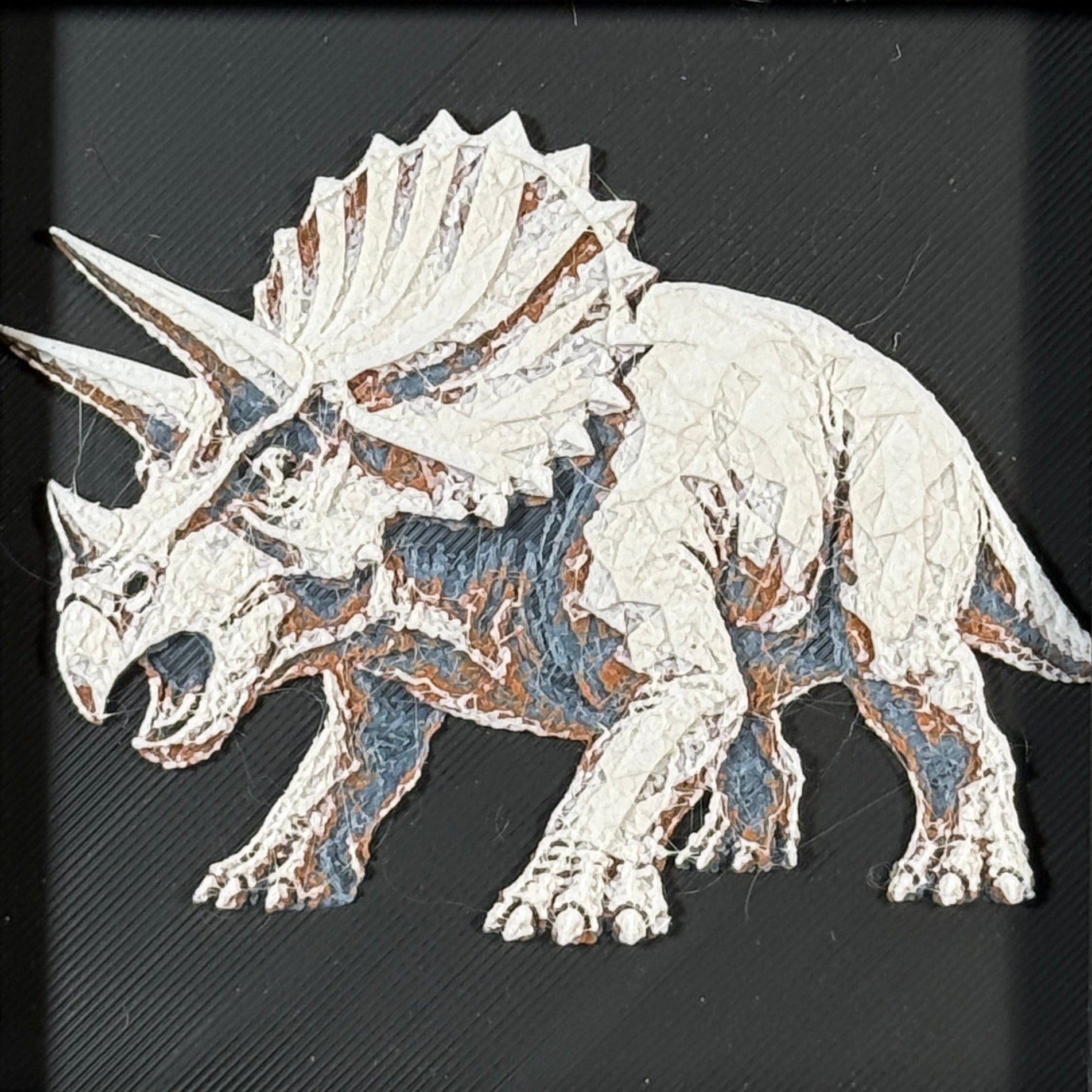 Framed geometric Triceratops layered 3D art piece featuring a stylized dinosaur design in a classic Heritage monochrome grey and white palette.