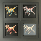 Four-panel framed geometric Velociraptor layered 3D art set showing the Velociraptor design in Heritage, Crimson Ice, Royal Gold, and Teal Orange color palettes inside a charcoal matte four-pack display frame.