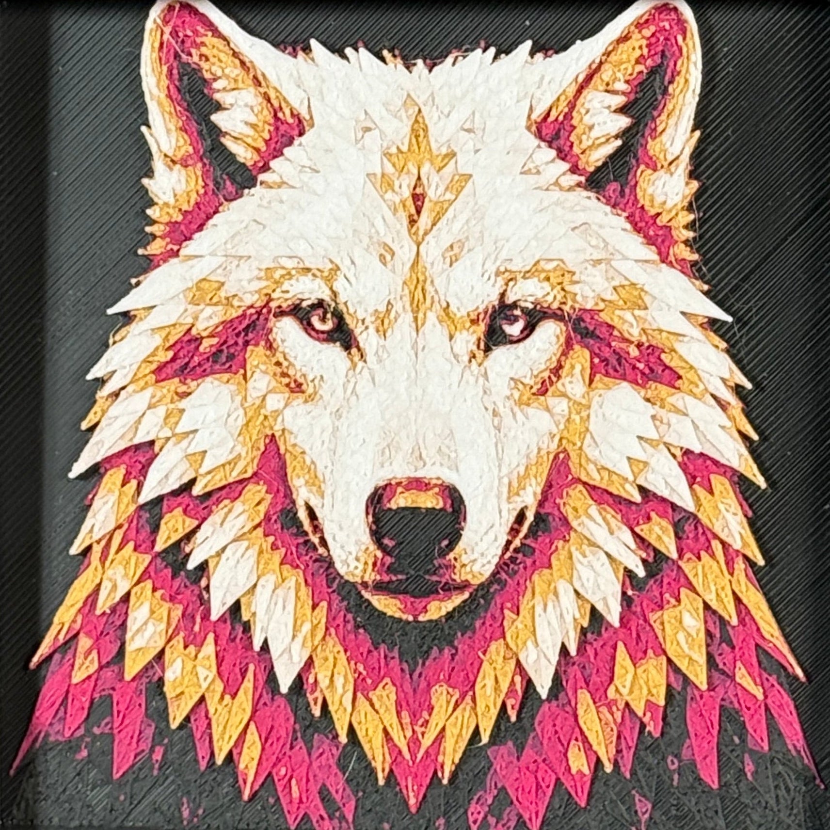 Geometric wolf framed layered 3D art in Crimson Ice color palette, featuring a bold wolf portrait with cyan, red, black, and white layered details inside a charcoal matte display frame.