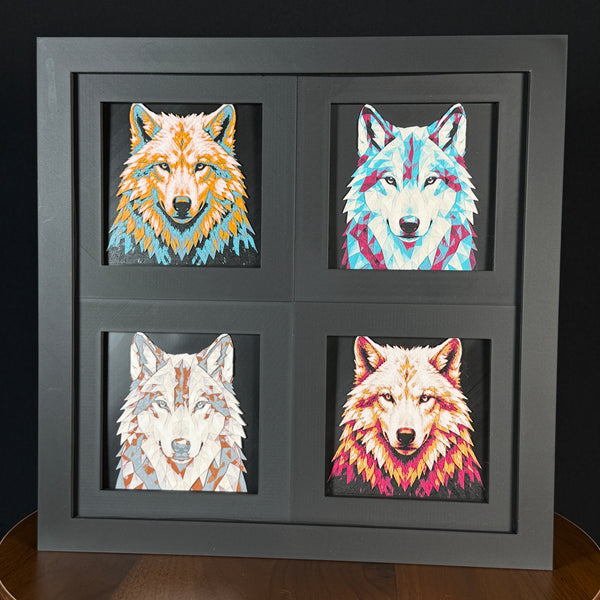 Four-panel framed geometric wolf layered art set showing the same front-facing wolf portrait in four WTX3D color palettes, arranged in a charcoal black 2x2 frame with sharp ears, detailed fur texture, and high-contrast layered color.