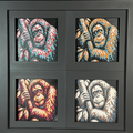 Geometric chimpanzee framed layered 3D art in mixed color palette, featuring a gorilla portrait with gold, blue, black, and white layered details inside a charcoal matte display frame.