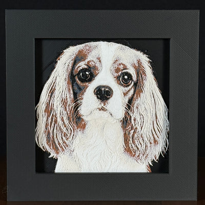 Framed 3D layered art piece featuring a highly detailed, textured portrait of a Cavalier King Charles Spaniel dog with long silky ears, large expressive eyes, and a brown and white coat pattern.