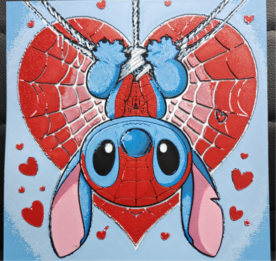 Framed 3D layered art piece featuring an adorable illustration of a cute blue alien character dressed in a red, web-patterned comic hero mask and torso, hanging upside down from a silver thread in front of a large red heart with web details, surrounded by smaller red hearts against a light blue background.