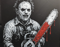 Framed 3D layered art piece featuring a detailed grayscale illustration of a classic horror movie slasher wearing a stitched leather mask and holding a chainsaw accented with bright red blood details.