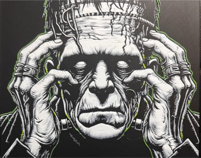 Framed 3D layered art piece featuring a detailed grayscale illustration of a classic horror monster with a flat-topped head and bolts in his neck, gripping his head with both hands against a dark background.