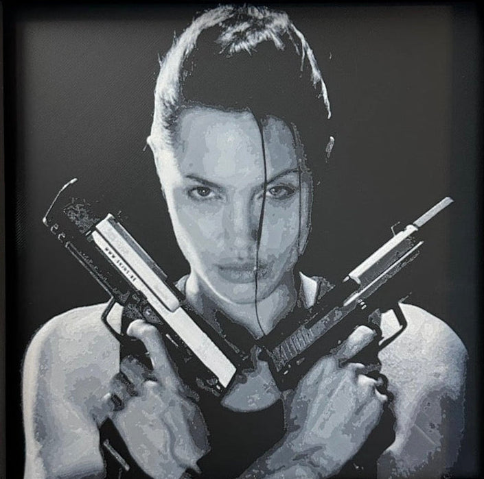 Framed 3D layered art piece featuring a dual pistol heroine in grayscale.