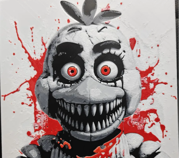 Framed 3D layered art piece featuring a creepy animatronic chicken creature with wide orange eyes and multiple rows of sharp teeth, accented with red splatter details on a light background.